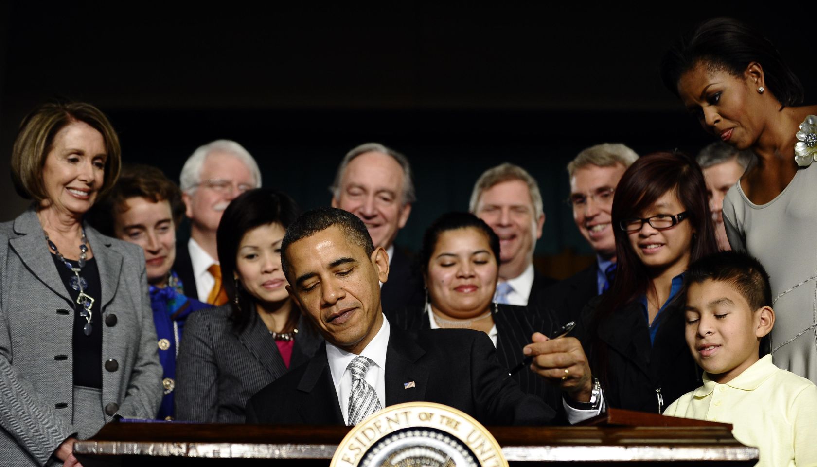 US President Barack Obama signs into law