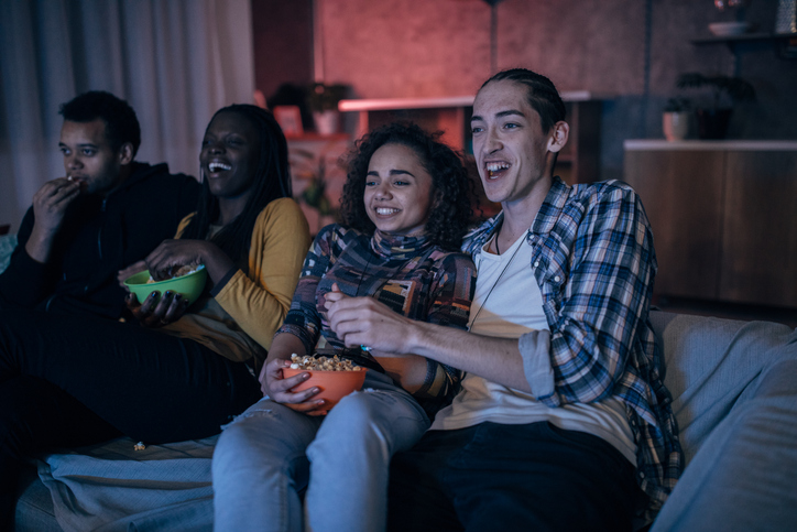 Multi-ethnic friends watching TV